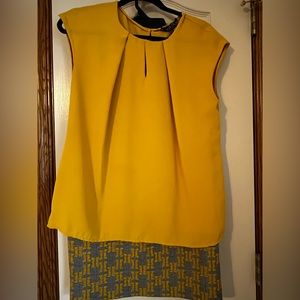 Yellow sleeveless top with patterned matching skirt.